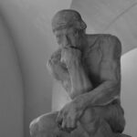 a black and white photo of a statue of a man